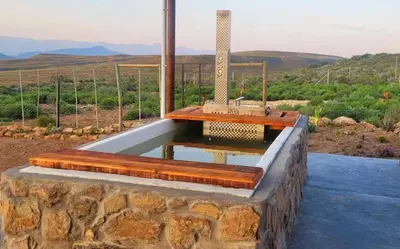 a pool of water on top of a stone wall at Phumelela Private Game Farm in Pinegrove
