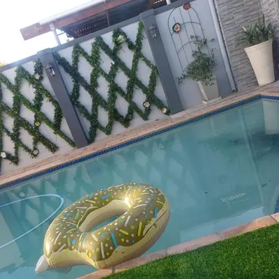 a swimming pool with a pretzel in the water at Rondebosch East Garlandale STRICTLY HALAAL, fresh garden cottage in Cape Town