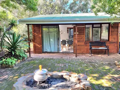 a small house with a fire pit in front of it at 81 Kingfisher in Lake Marina
