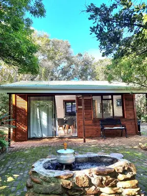 a house with a fire pit in the yard at 81 Kingfisher in Lake Marina