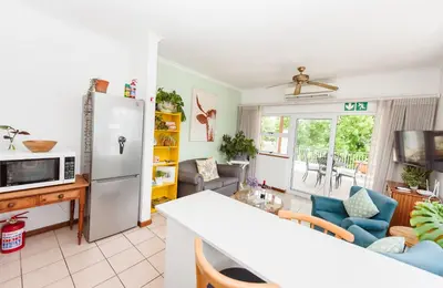 a kitchen and living room with a refrigerator at Luxury suite near Church Street in Stellenbosch
